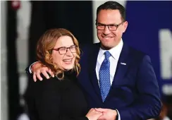  ?? (Mark Makela/Getty Images/JTA) ?? SHAPIRO EMBRACES his wife, Lori, on stage after giving his victory speech.