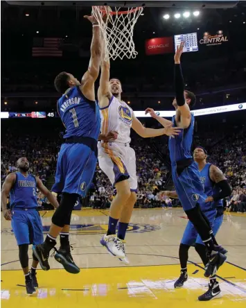  ?? ASSOCIATED PRESS ?? Golden State Warriors' Klay Thompson drives to the basket next to Dallas Mavericks' Justin Anderson during the first half of an NBA basketball game in Oakland, Calif.