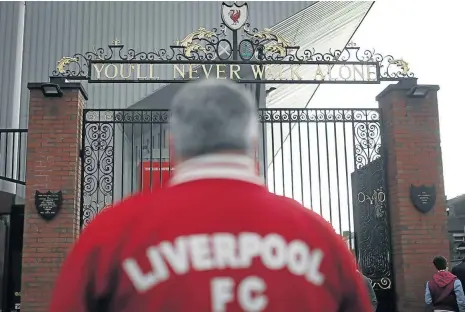  ?? REUTERS ?? EVERYONE’S UNITED:
A fan outside Anfield Stadium, the home of Liverpool Football Club