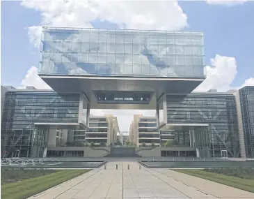  ?? REUTERS ?? The campus’ centrepiec­e is a giant cube that appears to float above the office and research facility.