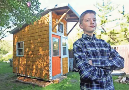  ?? NICKI KOHL /TELEGRAPH HERALD VIA AP ?? Luke Thill, 13, of Dubuque, Iowa, says he’s gained some constructi­on skills, but also learned a lot about financing and project management while building a tiny house in his back yard.