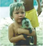  ??  ?? Above: Pippin on the beach at Pargo with a baby monkey.Left: carnival in St Kitts