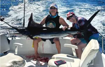  ?? PROVIDED PHOTOS ?? ABOVE: Maribel Martinez with a striped marlin and friend Casey Kurete. LEFT: Orca whale at Cabo Pulmo National Marine Park in Mexico. BELOW: Manny Martinez with Jana Zermeno-Torres (right) on Dec. 31.