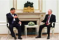  ?? (Sergei Karpukhin, Sputnik, Kremlin pool photo via AP) ?? Chinese President Xi Jinping gestures as he speaks to Russian President Vladimir Putin Monday during their meeting at the Kremlin in Moscow, Russia.