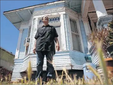  ?? Robert Gauthier Los Angeles Times ?? RAMON TENORIO stands outside his house in Boyle Heights, where the paint has been peeling, in June.