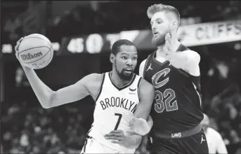  ?? ?? Cleveland Cavaliers forward Dean Wade (32) defends Brooklyn Nets forward Kevin Durant (7) in the second quarter at Rocket Mortgage FieldHouse. Mandatory Credit: David Richard-USA TODAY Sports