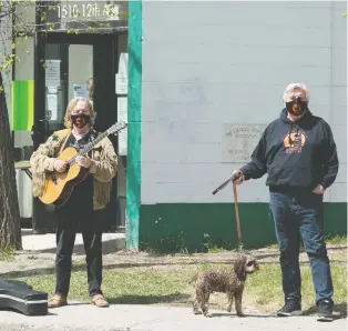  ?? BRANDON HARDER ?? Musician Jack Semple and Karl Fix, president of the Dog River Howlers Rugby Club, stand Friday near the Carmichael Outreach building on 12th Avenue.