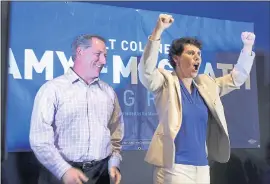  ?? JAMES CRISP — THE ASSOCIATED PRESS ?? Amy McGrath, right, with her husband, Erik Henderson, pumps her fists after being elected as the Democratic candidate for Kentucky’s 6th Congressio­nal District Tuesday,