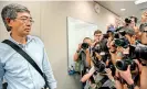  ??  ?? Previously missing Hong Kong bookseller Lam Wing-kee (L) is photograph­ed by the press as he arrives to hold a press conference at the Legislativ­e Council in Hong Kong on June 16. AFP
