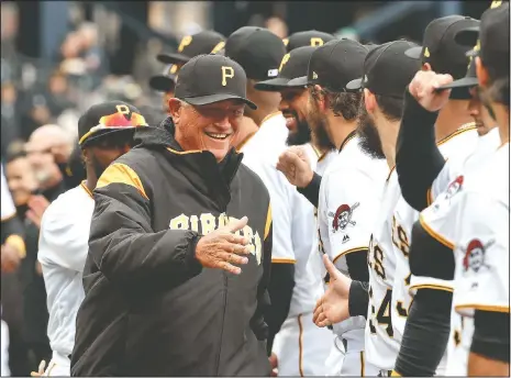  ?? (File Photo/AP/Gene J. Puskar) ?? Pittsburgh Pirates’ Clint Hurdle (left) greets players in 2018 as he is introduced before the Pirates’ home opener baseball game against the Minnesota Twins in
Pittsburgh.