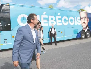  ?? JACQUES BOISSINOT/THE CANADIAN PRESS ?? Bloc Québécois Leader Yves-françois Blanchet and spouse Nancy Deziel in Lévis on Friday. He drew the ire of environmen­talists when he said the Quebec government's tunnel scheme between Quebec City and Lévis had ecological potential.