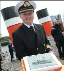  ??  ?? Captian Ross Cochrane with a cake to mark the anniversar­y