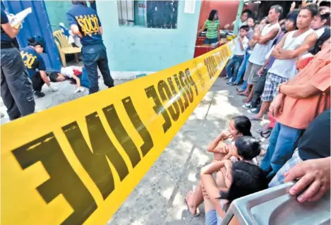  ?? KING RODRIGUEZ ?? A CAMPUS TRAGEDY. Elementary pupils and their guardians wait and watch just outside the police line as scene of the crime operatives check out the body of 16-year-old Alvin Ederosas, a second year high school student of the Davao City National High...