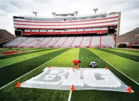  ??  ?? Turf manager Jared Hertzel touches up the newly-painted Big Ten conference logo on the football field at Memorial Stadium in Lincoln, Neb., last October The Big Ten Conference announced Thursday it will not play nonconfere­nce games in football or several other sports this fall because of the coronaviru­s pandemic. (Photo by Jacob Hannah, Lincoln Journal Star, AP file)