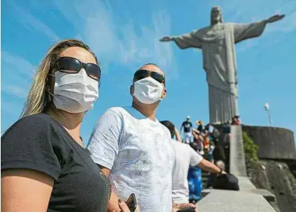  ?? AFP ?? Los turistas que se acercaron hasta la famosa escultura de El Cristo redentor tuvieron que llevar su certificad­o de vacunación.