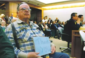  ?? PHOTOS BY LUKE E. MONTAVON/THE NEW MEXICAN ?? Bob Eichhorst of Corrales, left, a member of Local 412 Plumbers & Pipe Fitters, holds a thank you sign to the Senate Public Affairs Committee after it tabled a ‘right to work’ bill Tuesday.