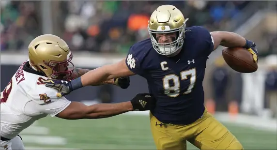  ?? DARRON CUMMINGS — THE ASSOCIATED PRESS ?? Notre Dame tight end Michael Mayer runs past Boston College defensive back Jaiden Woodbey during the first half of a Nov. 19, 2022 game in South Bend, Ind.