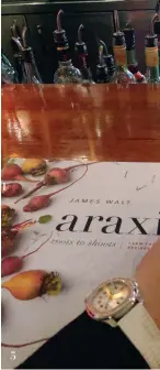  ??  ?? 5 Browsing through Araxi’s Chef James Walt Cookbook while waiting for our table
5