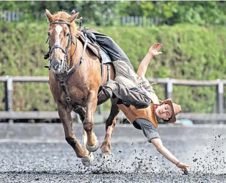  ??  ?? A cowboy demonstrat­es trick riding at the Royal Armouries in Leeds as it hosts a Wild West Horse Show for the bank holiday weekend. The Atkinson Action Horses have worked on TV shows such as Poldark and Peaky Blinders.