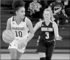  ?? Photos by Gerren Smith ?? Above: Lady Warriors’ Lizzy Rowton (10) conducts the offense against Woodlawn. Below: Lady Warriors’ defense of Gabby Buras (44) goes to disrupt Woodlawn’s offensive attack with Lauren Daniell (21) standing guard during action.