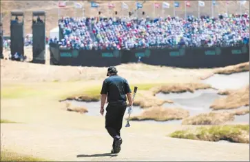  ?? Matt York Associated Press ?? PHIL MICKELSON walks to the 18th green during the f inal round of the U. S. Open. He closed with a threeover 73 to f inish at 13 over. After opening with a promising 69, the f ive- time major winner shot 74- 77- 73.