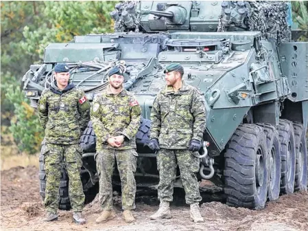  ??  ?? Canadian Army soldiers stand next to their LAV 6 armored personnel carrier during NATO enhanced Forward Presence battle group military exercise Silver Arrow in Adazi, Latvia, Oct. 5, 2019.