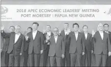  ?? —AFP ?? World leaders pose for a photo during the Asia-Pacific Economic Cooperatio­n (APEC) Summit in Port Moresby on Sunday.