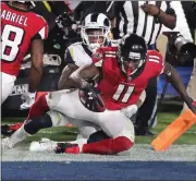 ?? Curtis Compton / Atlanta Journal-Constituti­on via AP ?? Atlanta Falcons wide receiver Julio Jones catches a touchdown pass past Los Angeles Rams defender John Johnson III during last week’s playoff game.