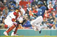  ?? Michael Dwyer / Associated Press ?? The Seattle Mariners’ Dee Gordon (9) scores on a double by Mitch Haniger as the Boston Red Sox’s Christian Vazquez, left, waits for the throw during the first inning in Boston on Saturday.