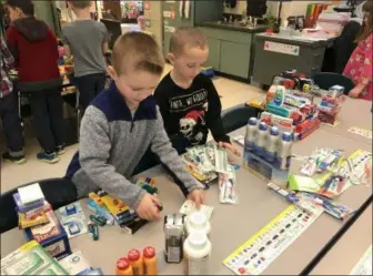  ?? PHOTO PROVIDED ?? Students at West Sand Lake Elementary help create care packages for soldiers who visited and spoke to them about being in the military.