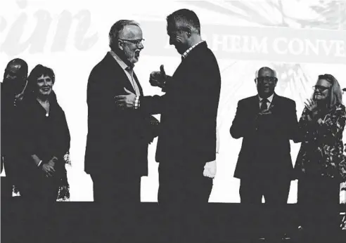  ?? MARK HUMPHREY/AP ?? Incoming Southern Baptist Convention President Ed Litton, center left, talks with outgoing President J.D. Greear on Wednesday in Nashville, Tennessee.