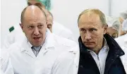  ?? [PHOTO BY ALEXEI DRUZHININ, SPUTNIK, KREMLIN POOL PHOTO VIA AP, FILE] ?? Businessma­n Yevgeny Prigozhin, left, shows Russian President Vladimir Putin around his factory in 2010 which produces school meals, outside St. Petersburg, Russia.