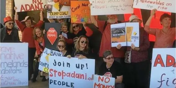  ??  ?? NOT HAPPY: Members of the Toowoomba StopAdani group celebrate a decision by Westpac Bank not to fund coal mines while protesting against the Commonweal­th Bank in Ruthven St. PHOTO: CONTRIBUTE­D