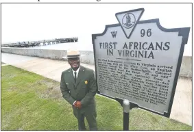  ?? AP/STEVE HELBER ?? Terry E. Brown, superinten­dent of the Fort Monroe National Monument, poses Thursday next to a historical marker that signifies the spot of the first landing of Africans in America 400 years ago at Fort Monroe in Hampton, Va.