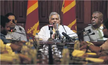  ?? AFP ?? Sri Lanka’s ousted prime minister Ranil Wickremesi­nghe, centre, takes part in a press conference in Colombo last month.