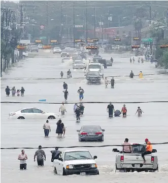  ?? THOMAS B. SHEA/AFP/GETTY IMAGES FILES ?? Hurricane Harvey became the first major hurricane to slam the United States since 2005. It also set a new tropical rainfall record with just over 60 inches (152 centimetre­s) in Texas. This year was the second-most costly year for storms worldwide since...