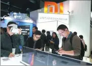  ?? ZHU XINGXIN / CHINA DAILY ?? Xiaomi’s mobile phones are on display at the 3rd World Internet Conference in Wuzhen, East China’s Zhejiang province.