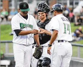  ?? MARC PENDLETON/STAFF ?? Manager Luis Bolivar pulls starter Adrian Rodriguez (left) as catcher Mark Kolozsvary looks on Monday during Kane County’s 13-4 victory over Dayton.