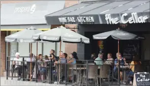  ?? JOE FRIES/Penticton Herald ?? Diners enjoy lunch Friday on the patio of The Cellar Wine Bar and Kitchen in downtown Penticton.