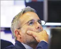  ?? AP PHOTO ?? Specialist Anthony Rinaldi works on the floor of the New York Stock Exchange, Wednesday. Stocks opened lower on Wall Street, following declines in Europe and Asia, after Washington threatened to expand tariffs on Beijing and China said it would...