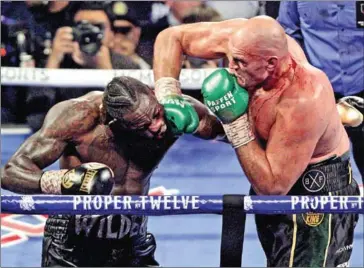  ?? AFP ?? Britain’s Fury (right) overpowere­d the US’ Wilder in Las Vegas in February, beating him in seven rounds.