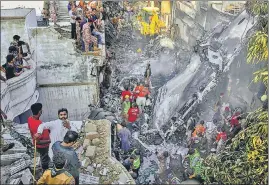  ?? AP ?? Rescue workers look for survivors at the site of the plane crash in Karachi on Friday.