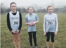  ??  ?? The Bourne Under 13 girls team of ( from the left), Molly Bennett ( 12th), Leah Clark ( 13th) and Megan Ellison ( 2nd) whowere second at Louth.