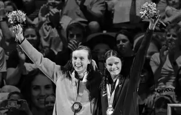  ?? Jeff Roberson, The Associated Press ?? Katie Ledecky and Katie Grimes wave on the podium at the medal ceremony for the women’s 800 freestyle on Saturday in Omaha, Neb.