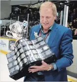  ?? TODD VANDONK/METROLAND ?? Peterborou­gh Petes alumni Bob Attwell carries the Memorial Cup onto the ice at the Memorial Centre during a pre-game ceremony that honoured the 1979 Memorial Cup champions. Attwell scored the winner in the 1979 Memorial Cup final.