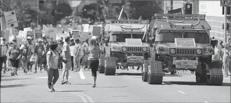  ?? AP/REED SAXON ?? Two electric-powered Humvees lead the way Saturday in the Los Angeles March for Science.