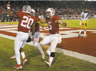  ?? Michael Macor / The Chronicle 2015 ?? Bryce Love (20) is greeted in the end zone after his long touchdown run in the fourth quarter in the 2015 Big Game. The Cardinal prevailed 35-22 at Stanford Stadium.