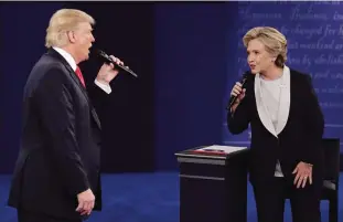  ??  ?? Republican presidenti­al nominee Donald Trump and Democratic presidenti­al nominee Hillary Clinton speak during the second presidenti­al debate at Washington University in St Louis. —AP