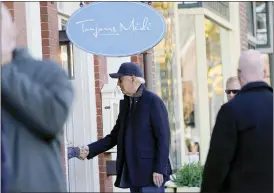  ?? SUSAN WALSH — THE ASSOCIATED PRESS ?? President Joe Biden shakes hands with a person as he visits shops with family members in Nantucket, Mass., Saturday.