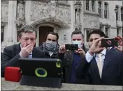  ?? FRANK AUGSTEIN — AP PHOTO ?? Uber drivers of the App Drivers & Couriers Union listen to the court decision outside the front of the Supreme Court in London on Friday.